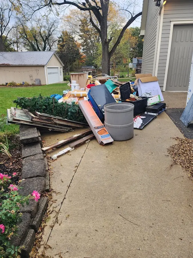 Dumpster being loaded with debris for 12 Yard Dumpster Rental in Morehead City